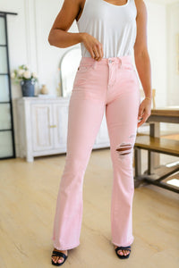 Feminine Flair Mid Rise Distressed Flares in Pastel Pink